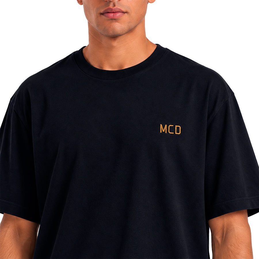 Camiseta Mcd Rosa Dólar Masculino — MCD dourado sobre o preto